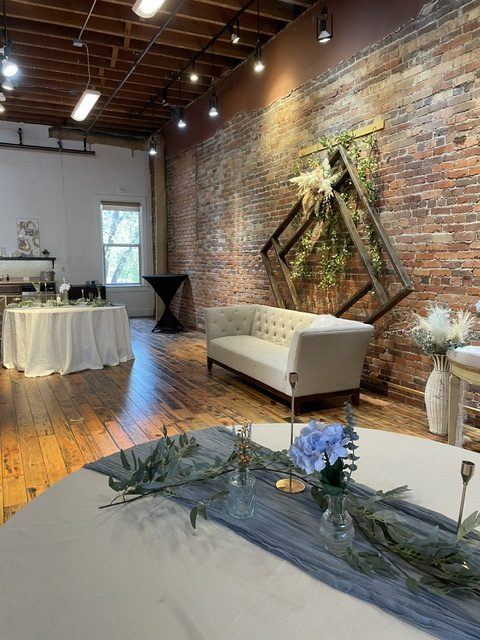 Set tables in the Ballroom beside the brick wall.