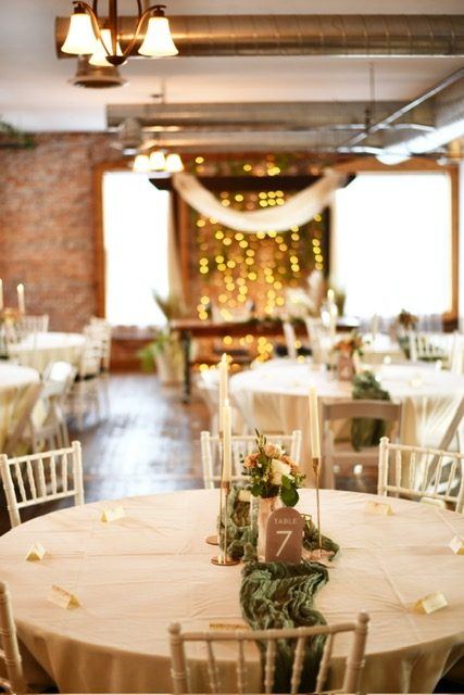 A table numbered seven under the Loft chandelier, with the string-light backdrop beyond.